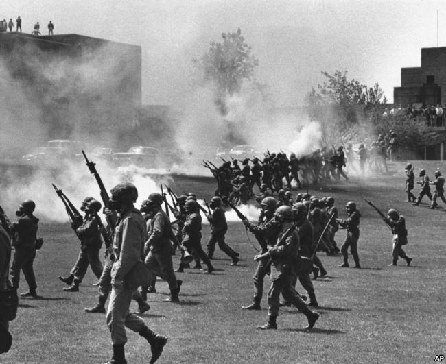 FILE - Ohio National Guard moves in on rioting students at Kent State University in Kent, Ohio, May 4, 1970. Four persons were killed and 11 wounded when National Guardsmen opened fire.