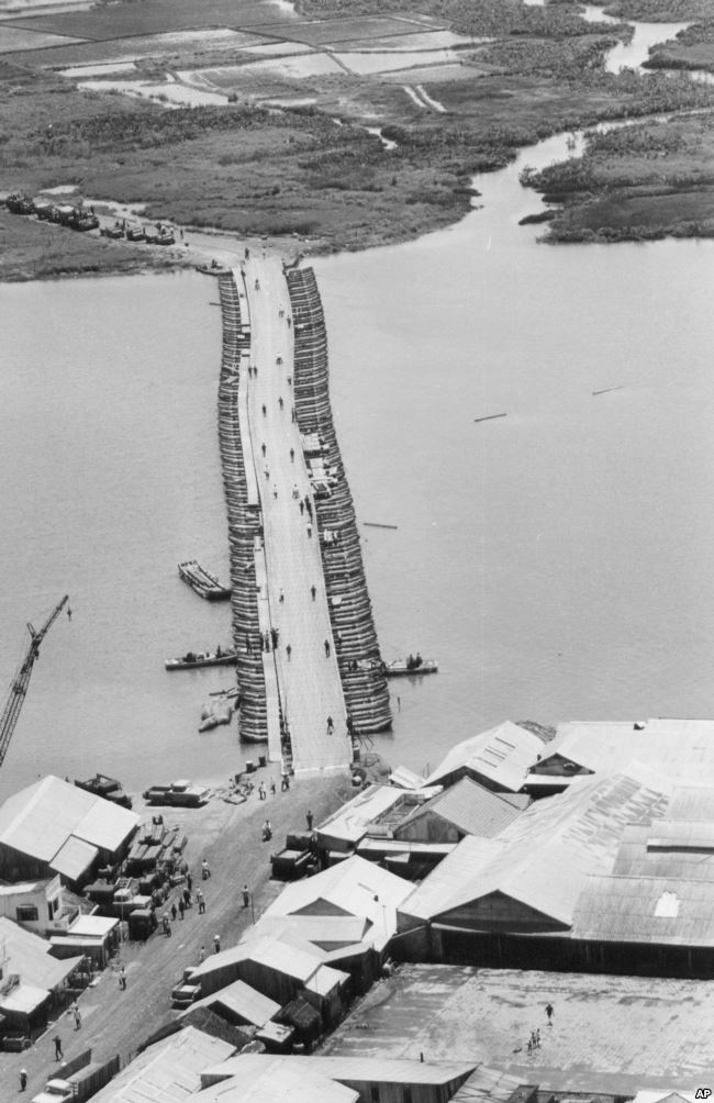 FILE - Military traffic is halted as U.S. Army engineers finish repairing a pontoon bridge damaged by a Viet Cong underwater mine, August 1968. Linking Saigon with the Mekong Delta, the bridge over the Oriental River replaced the permanent bridge, blown up by the enemy. Photo: VOA
